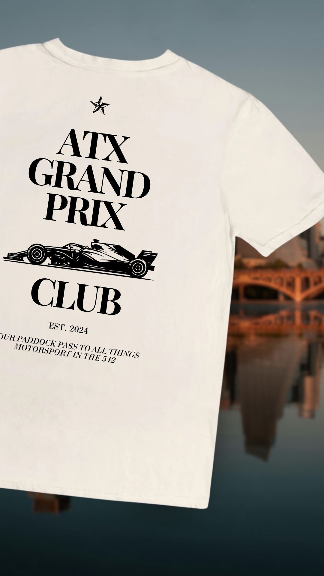 T-shirt with 'ATX Grand Prix Club' design on a blurred Austin background
