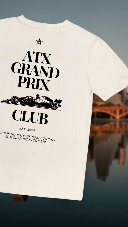 T-shirt with 'ATX Grand Prix Club' design on a blurred Austin background